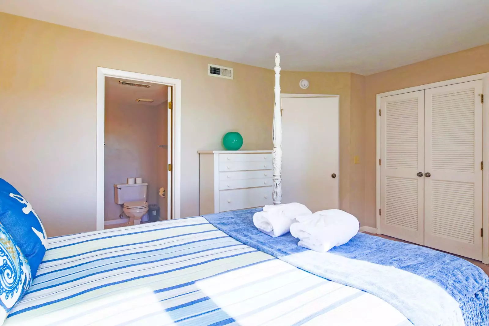 The master suite also has a dresser, closet and en suite bathroom.