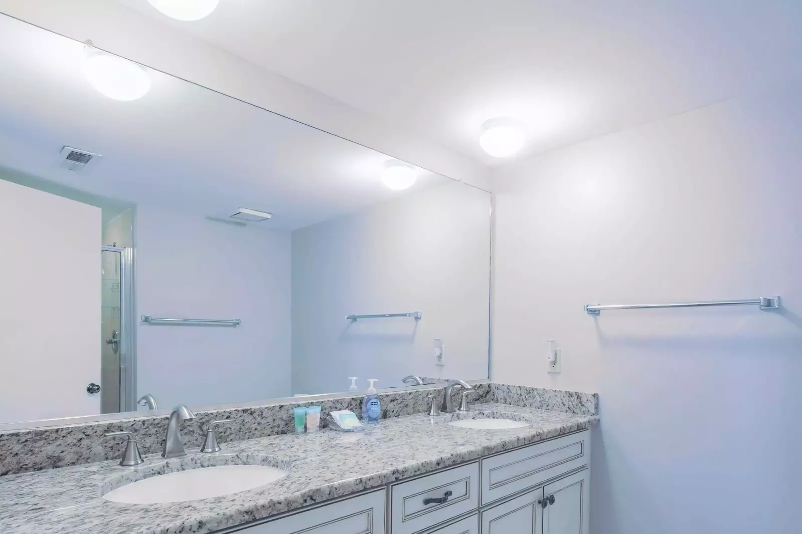 The en suite bathroom features a dual sink vanity.