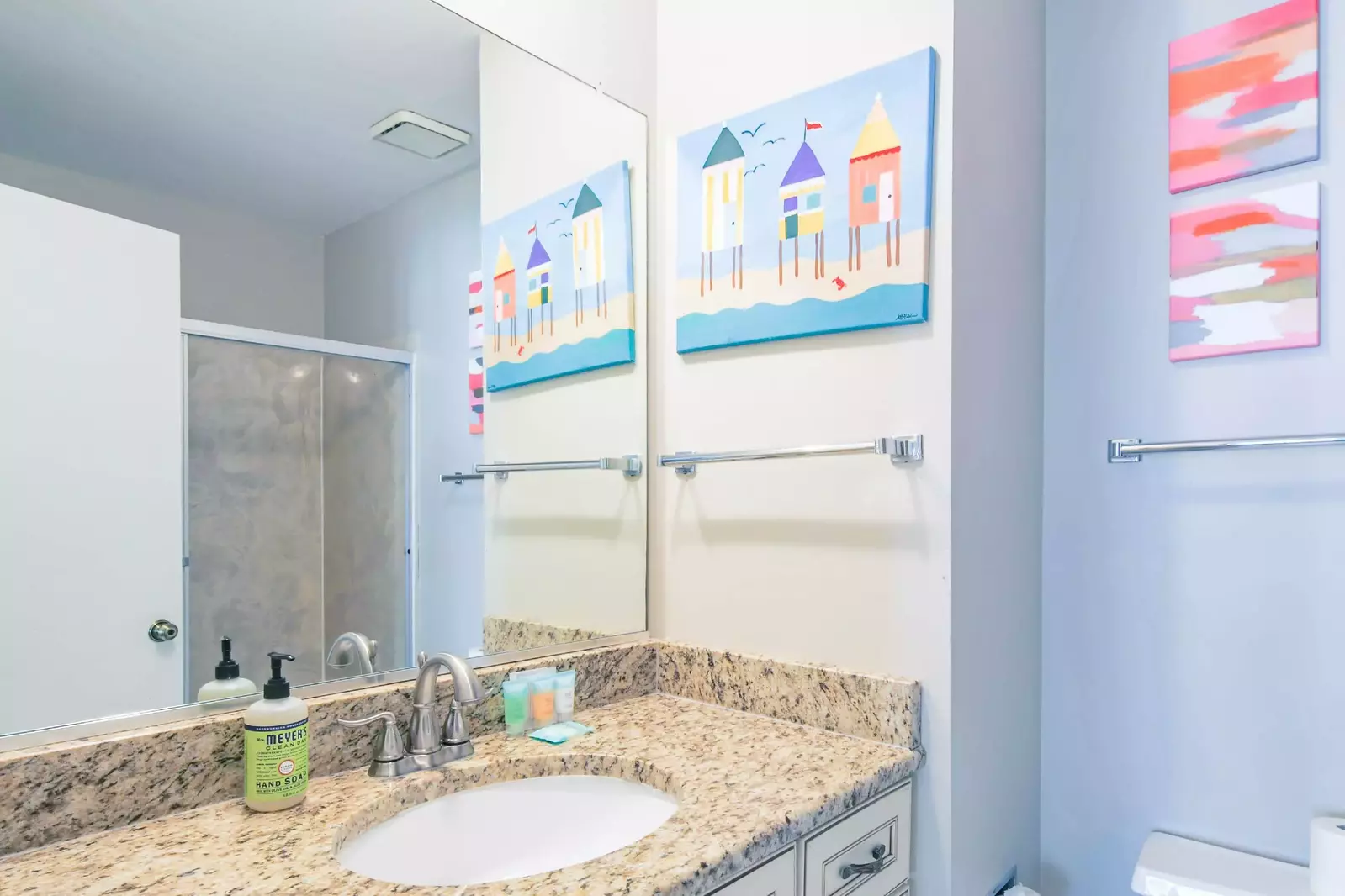 The en suite bathroom for the guest bedroom features a spacious vanity.