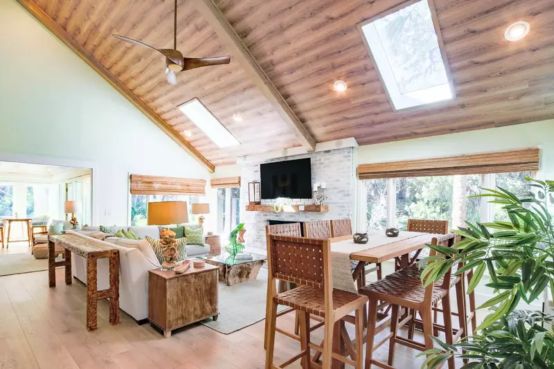 The dining area and living room feature lovely natural light and serene views of the martime forest.