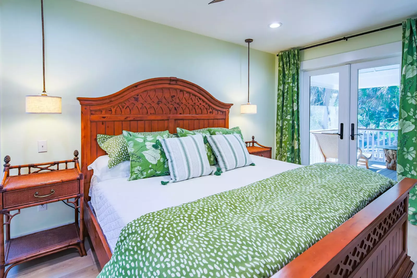 The master suite features a king bed and access to the screened porch.