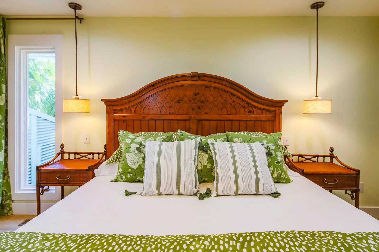 The master suite also features night stands and pendant lights.