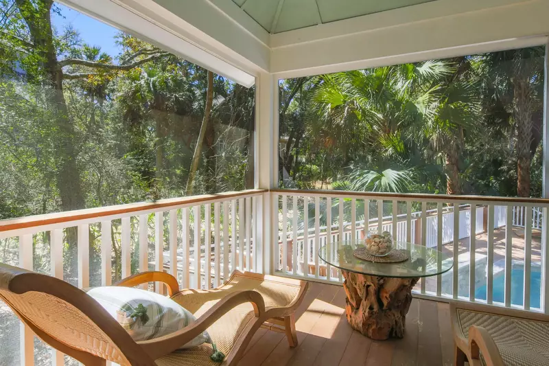 The master suite leads out to the screened porch that overlooks the pool.