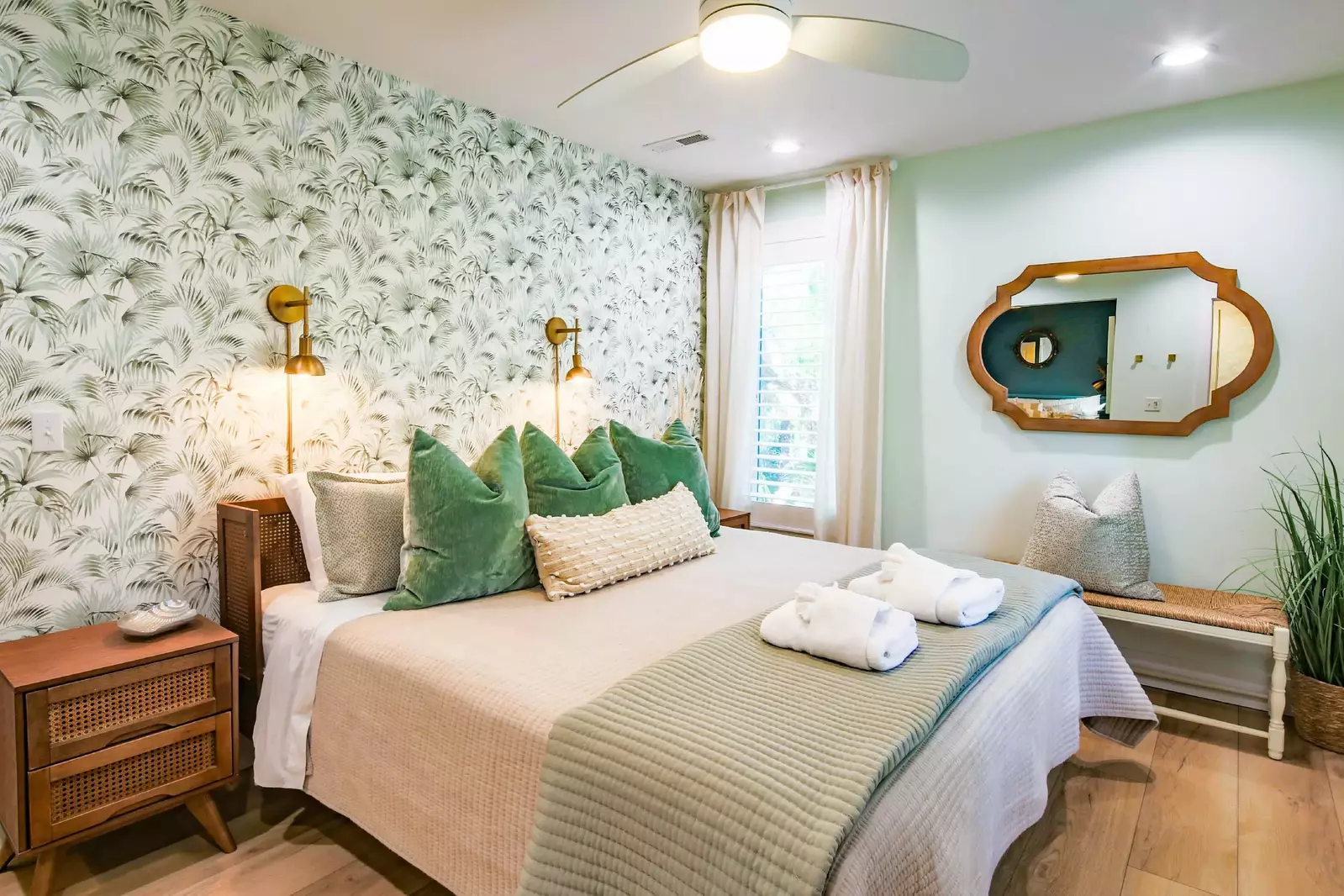 This upper level king suite features a king bed with night stands and wall sconces.
