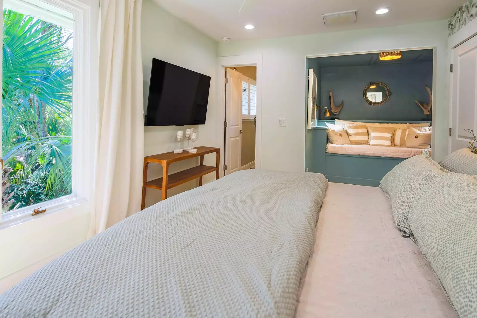 The king suite also features a wall-mounted smart TV, a reading nook and an en suite bathroom.