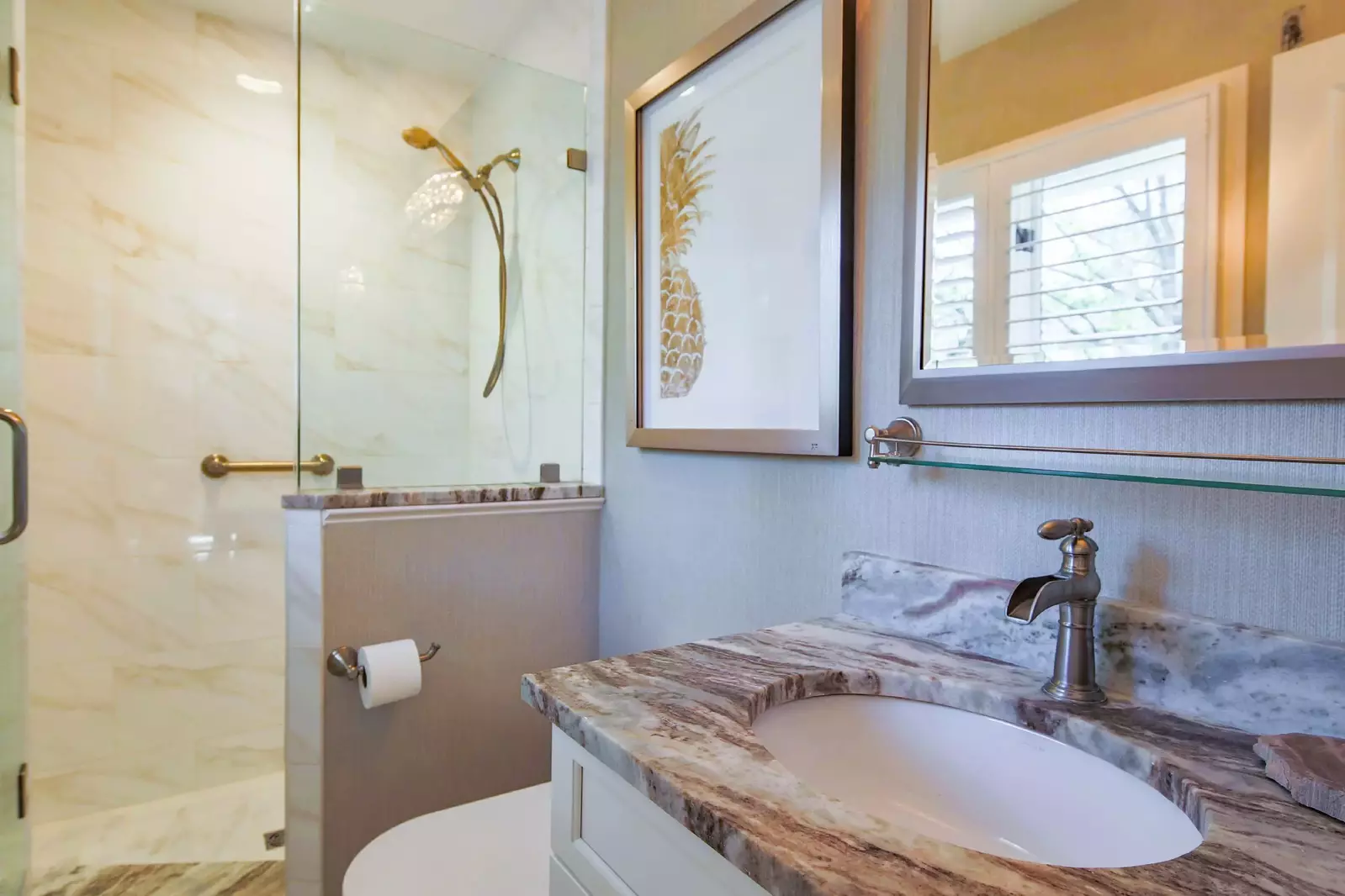 The en suite bathroom features a spacious vanity and tiled, walk-in shower.