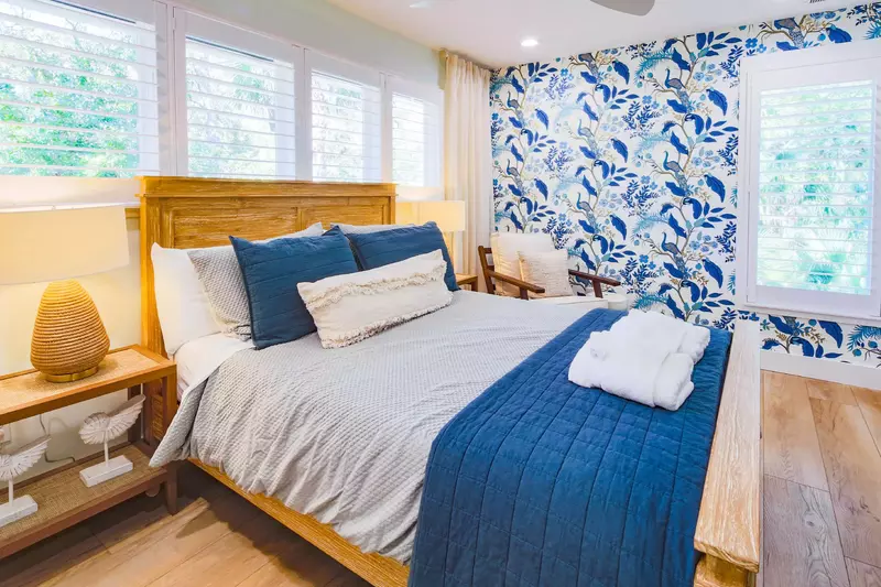 The upper level queen suite features a queen bed and night stands with reading lamps.