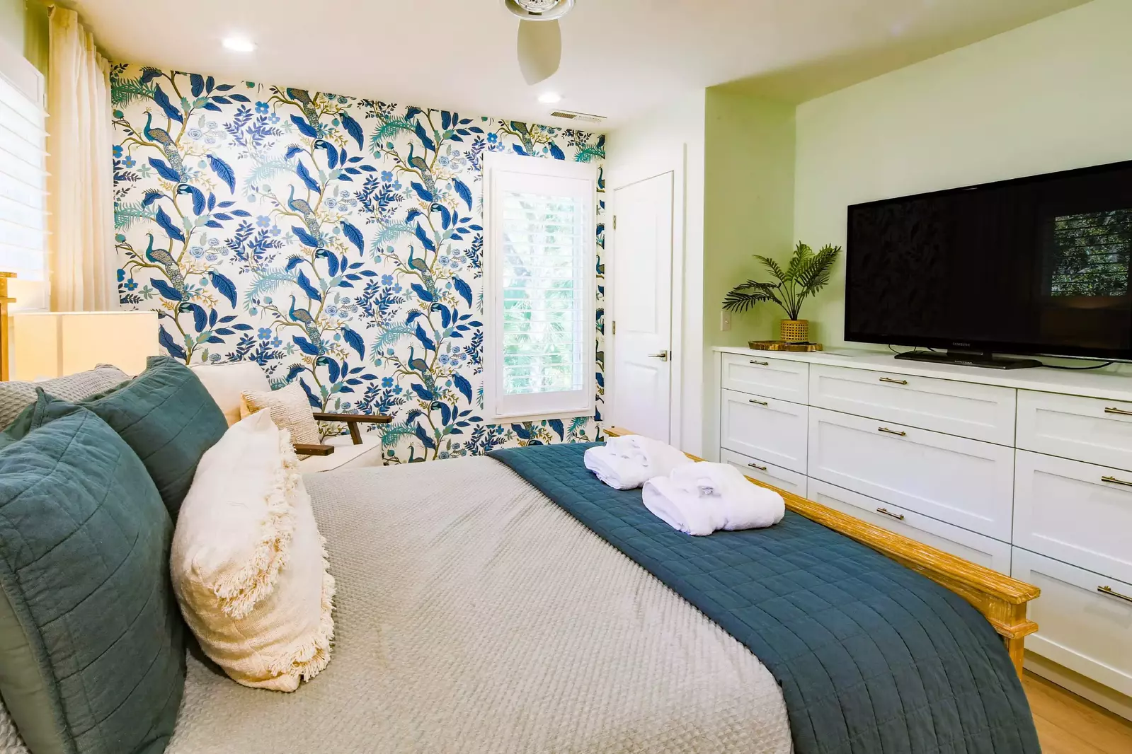 The queen suite features a built-in dresser, arm chair and flat screen TV.