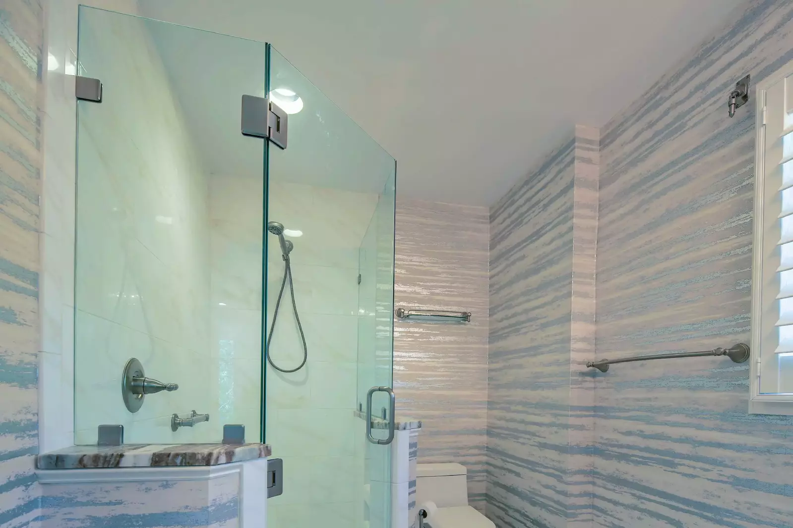 The en suite bathroom also has a tiled, walk-in shower.