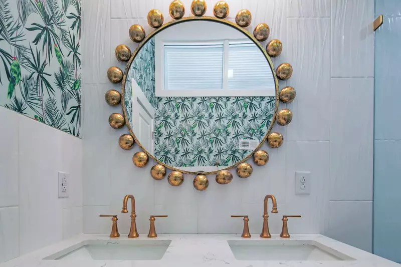 This hallway bathroom with a dual sink vanity is shared by the bunk bedroom and the twin bedroom.