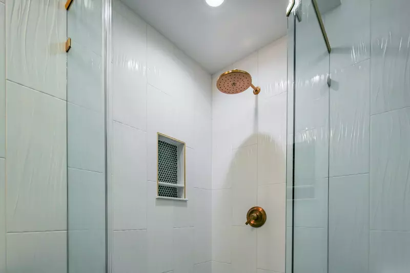 The hallway bathroom also has a tiled, walk-in shower.