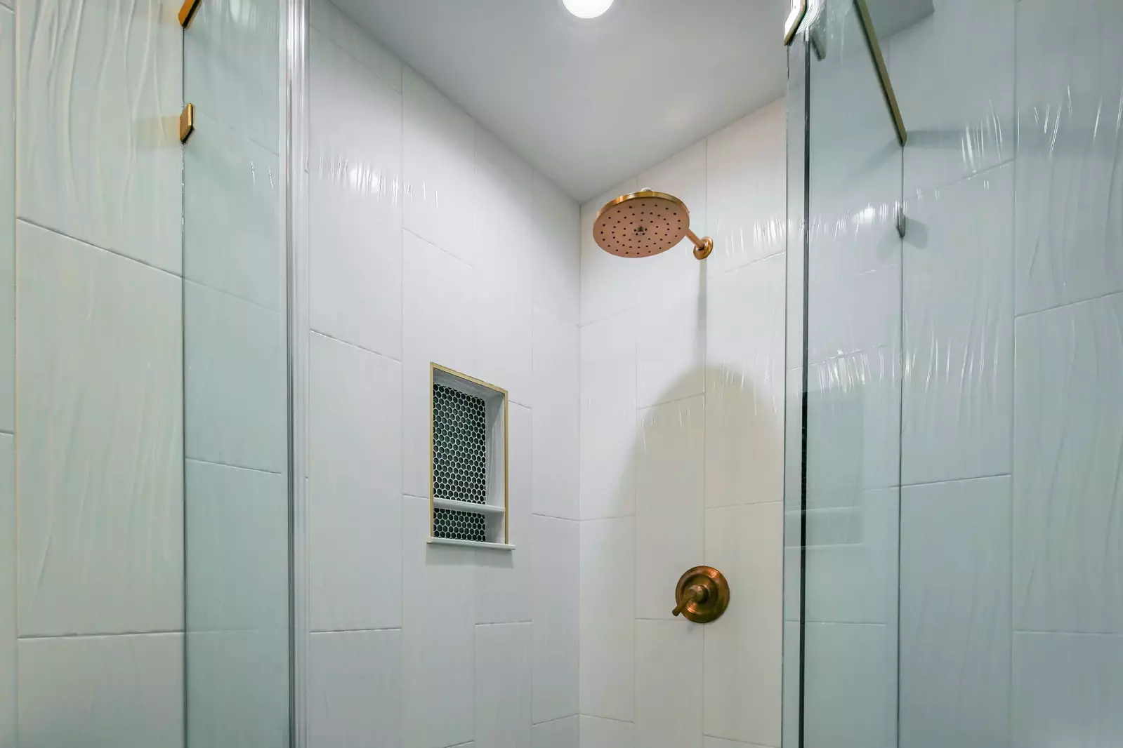 The hallway bathroom also has a tiled, walk-in shower.