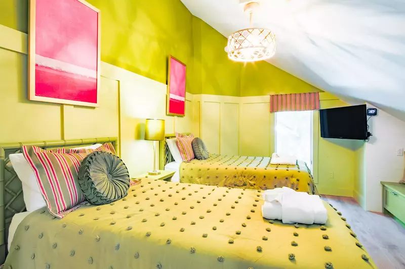 The twin bedroom also features a wall-mounted smart TV.