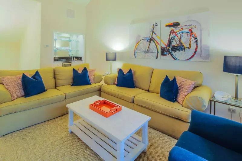 The living room features a comfortable seating area and vaulted ceilings.