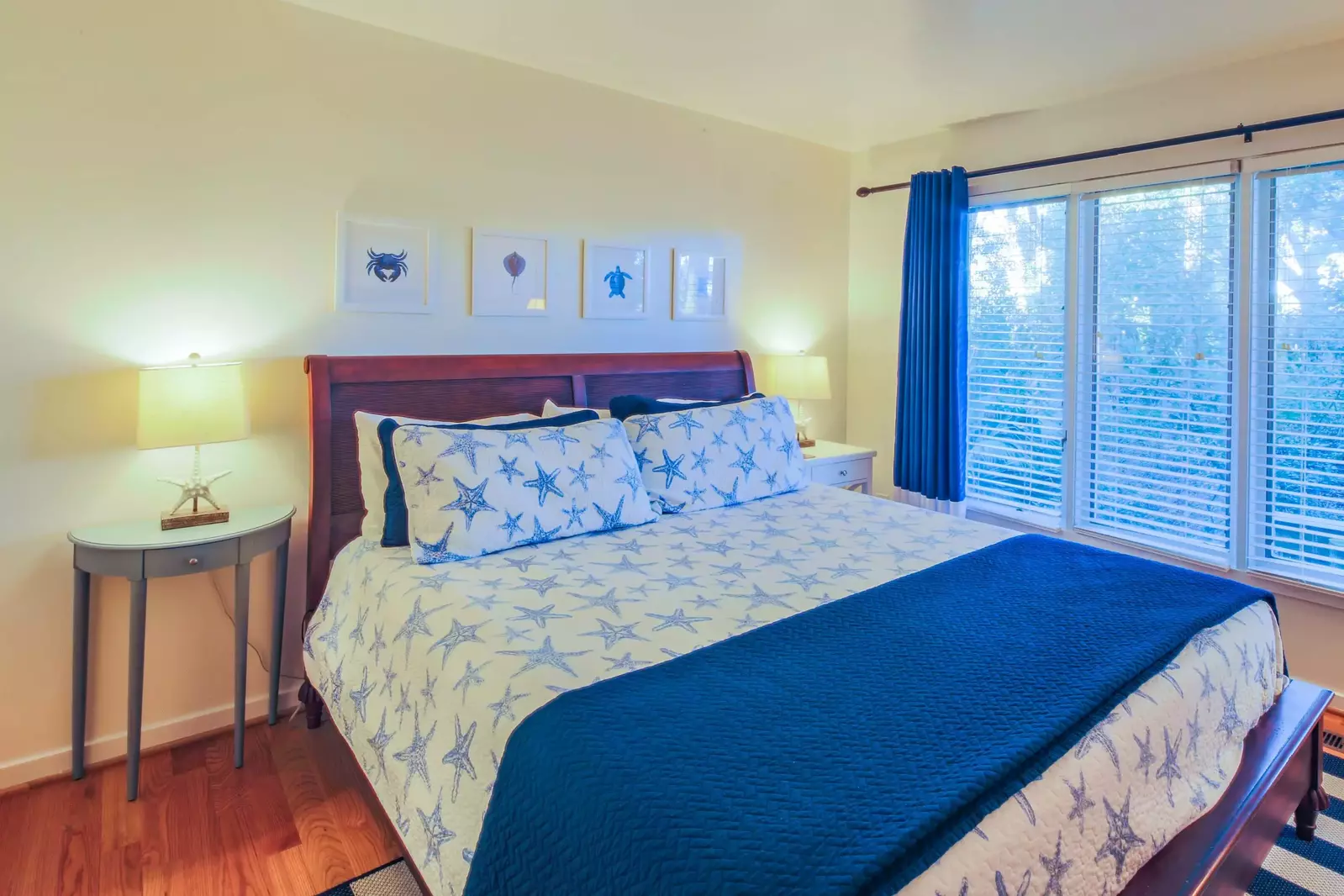 The primary suite features a king bed and night stands with reading lamps.
