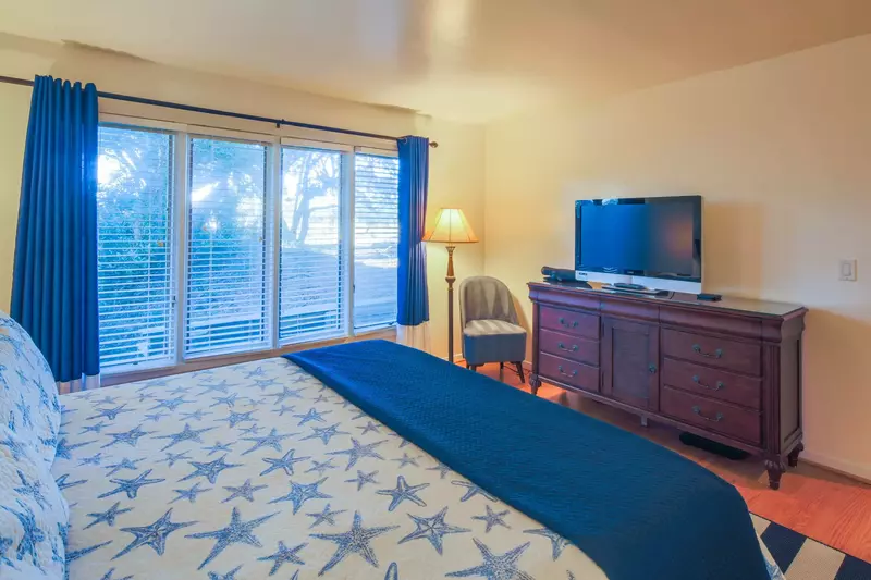 The primary suite also features a dresser, cable TV and chair.