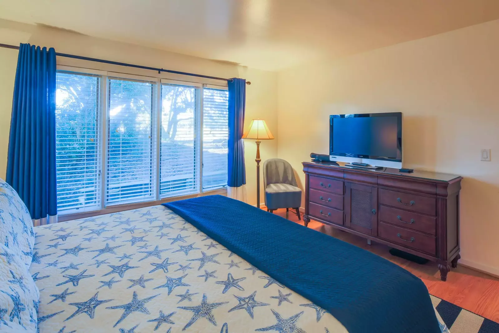 The primary suite also features a dresser, cable TV and chair.