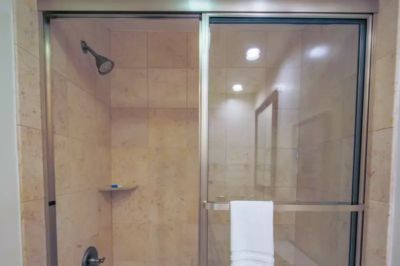 The primary bathroom also features a tiled, shower/tub combo.