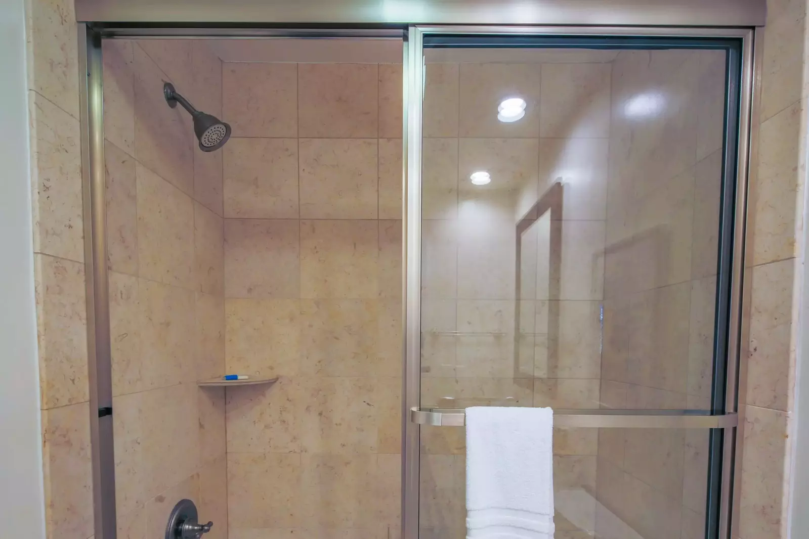 The primary bathroom also features a tiled, shower/tub combo.