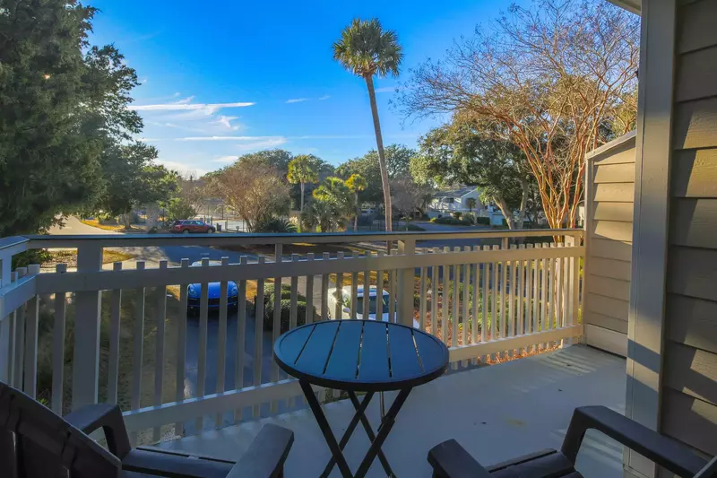 The front porch off of the guest suite looks out towards the Fairway Dunes community courts.