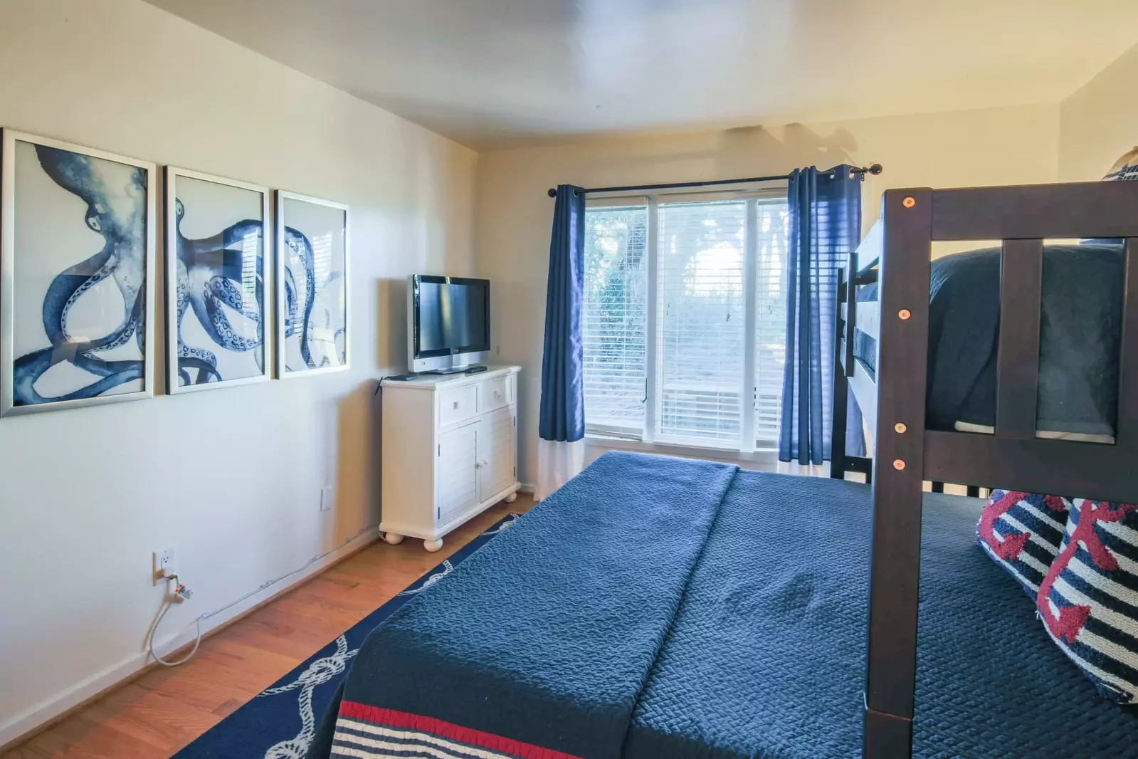 This suite also features a dresser, cable TV and a view out the back of the home.