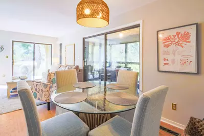 The dining table seats 4. There is an additional dining table on the screened porch.