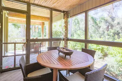 The screened porch connects to the home's back deck.