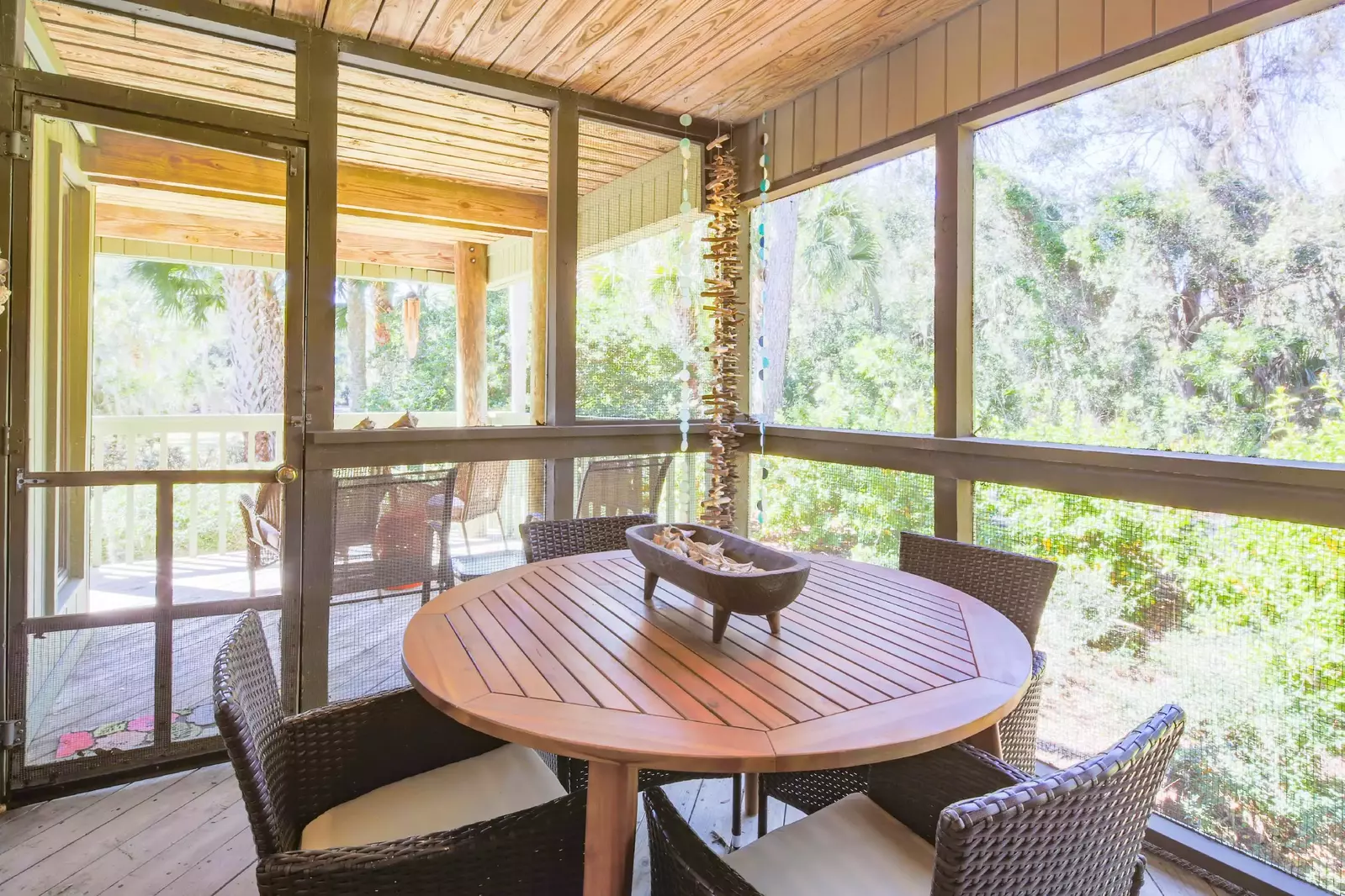 The screened porch connects to the home's back deck.