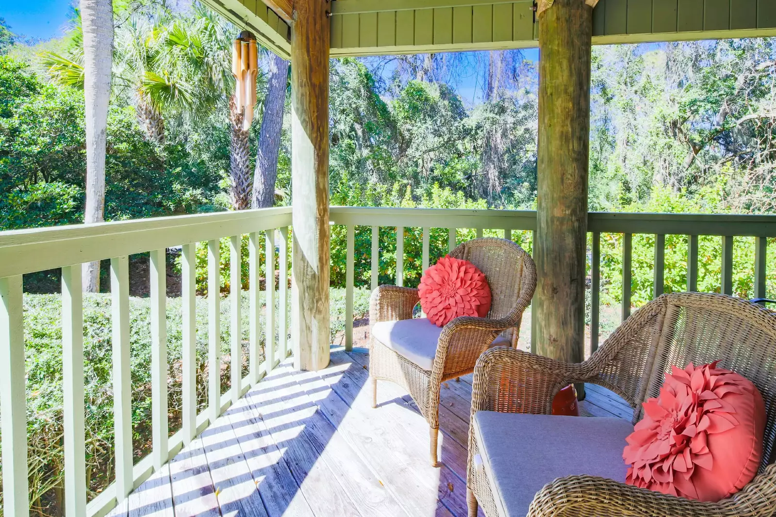 The covered porch, which is accessible from the screened porch and the living room, also has a seating area.