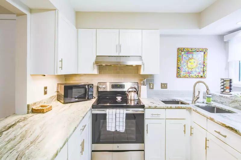 The kitchen also features two sinks and a countered ledge near the window.