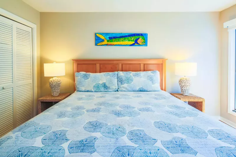 The master suite features a king bed and two night stands with reading lamps.