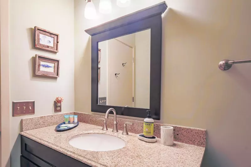 The renovated en suite bathroom features a spacious vanity.