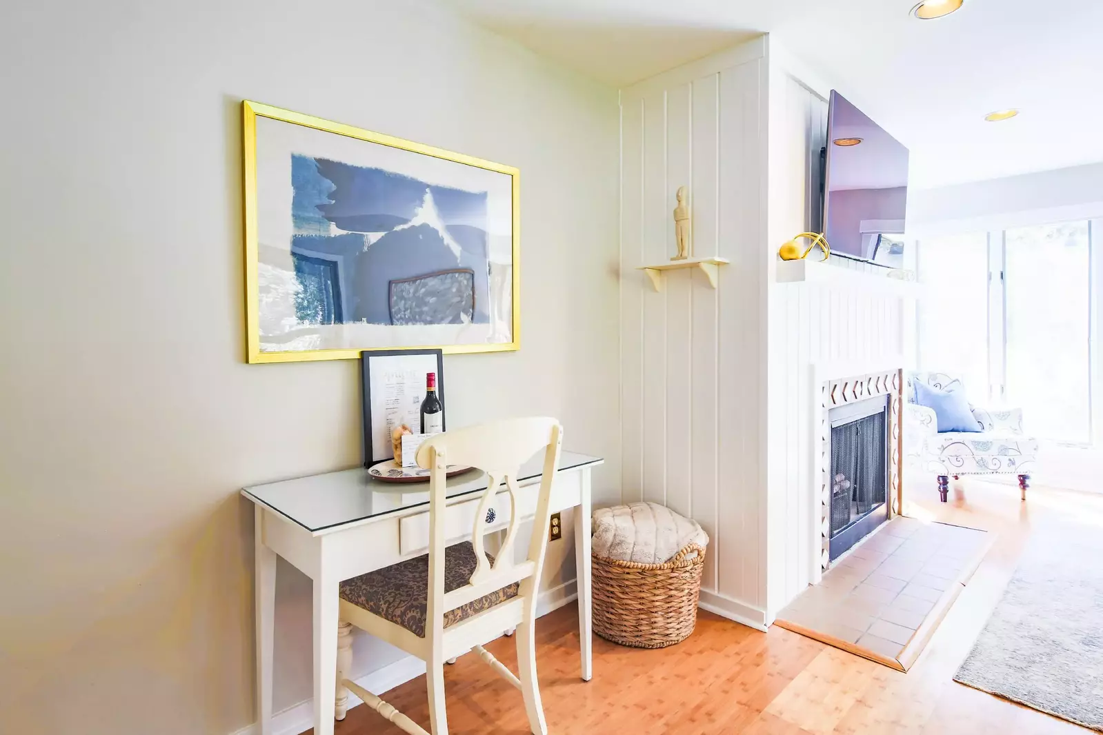 There is a desk and workspace near the dining table in the front room.