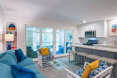 This newly renovated Seascape villa features an open floor plan layout between the kitchen & living room.