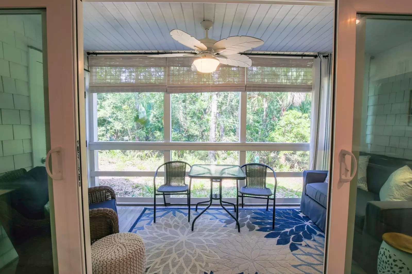 Step out onto the screened porch to find a cozy seating area with forest views.