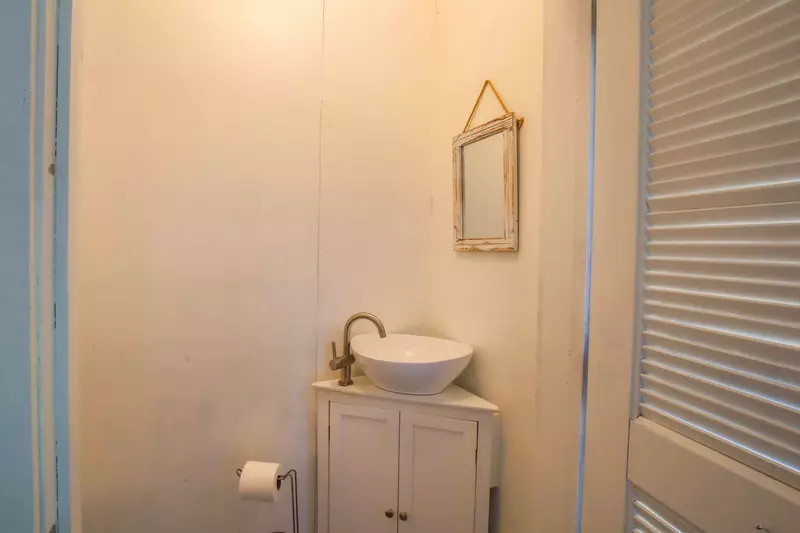 This half bathroom is located on the screened porch.
