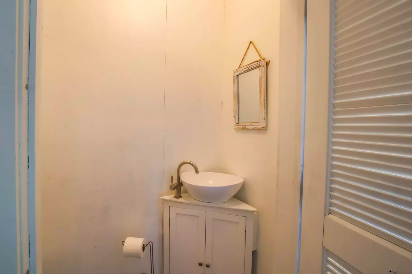 This half bathroom is located on the screened porch.