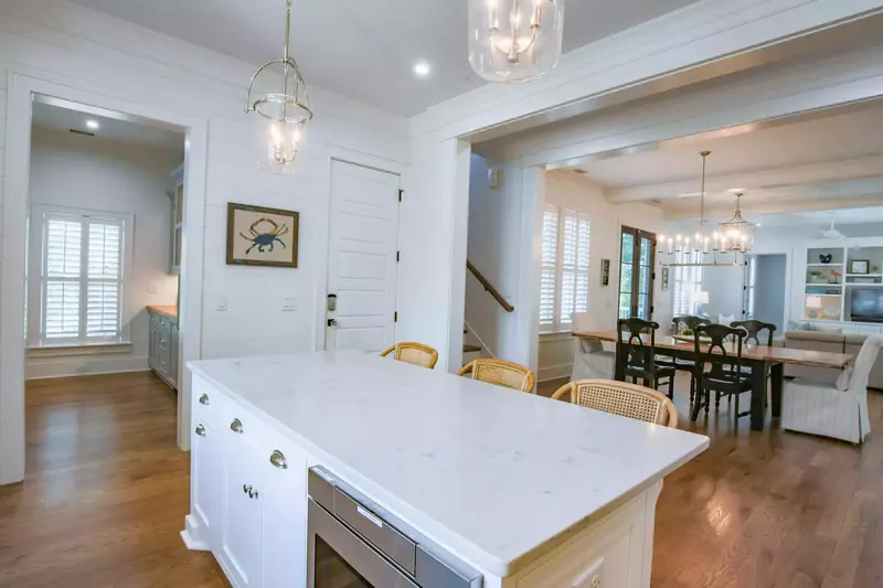 A spacious pantry, stairwell to the garage and stairwell to the second floor are located off of the kitchen.