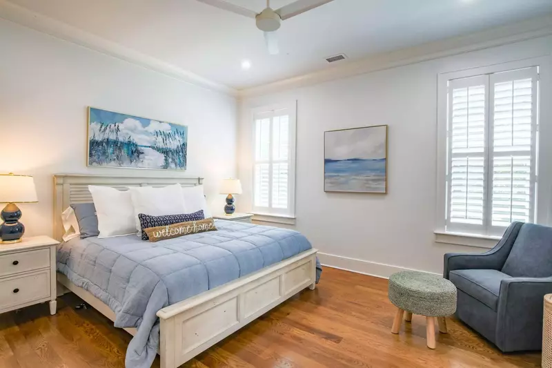 This master suite, located on the home's lower level, features a king bed and a seating area.
