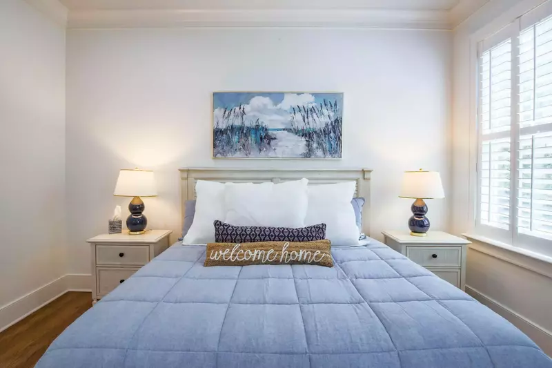 This king bed is flanked by two night stands with reading lamps.