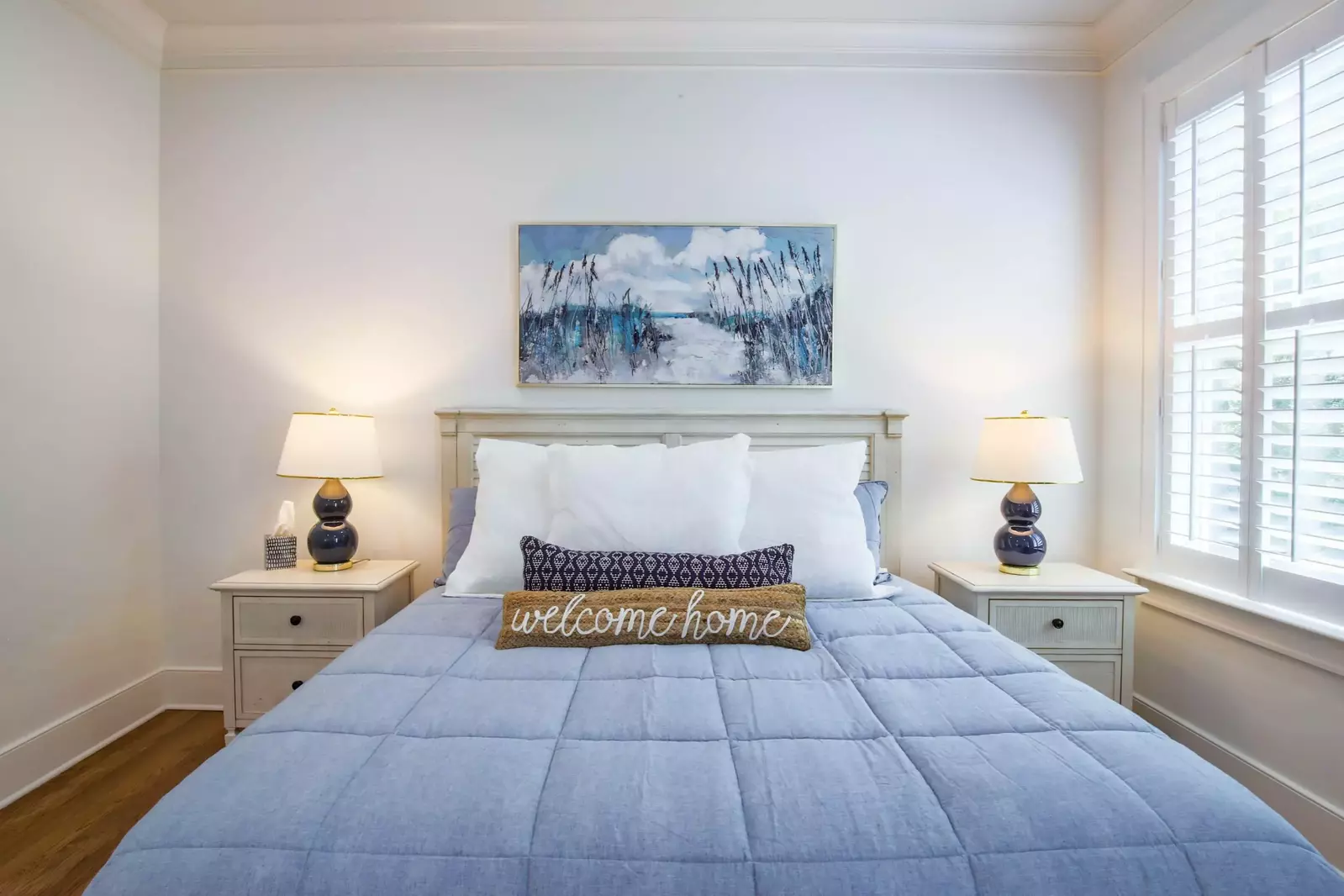 This king bed is flanked by two night stands with reading lamps.