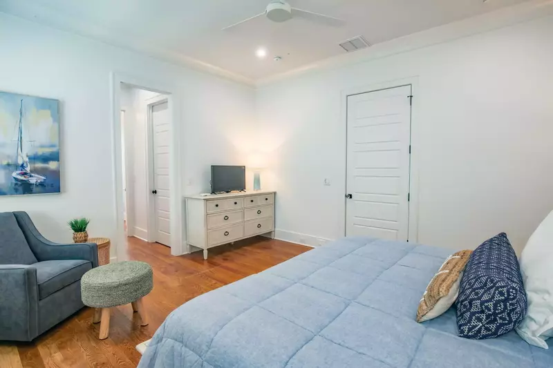 The en suite bathroom for this lower level bedroom is accessible through the small hallway in this photo.