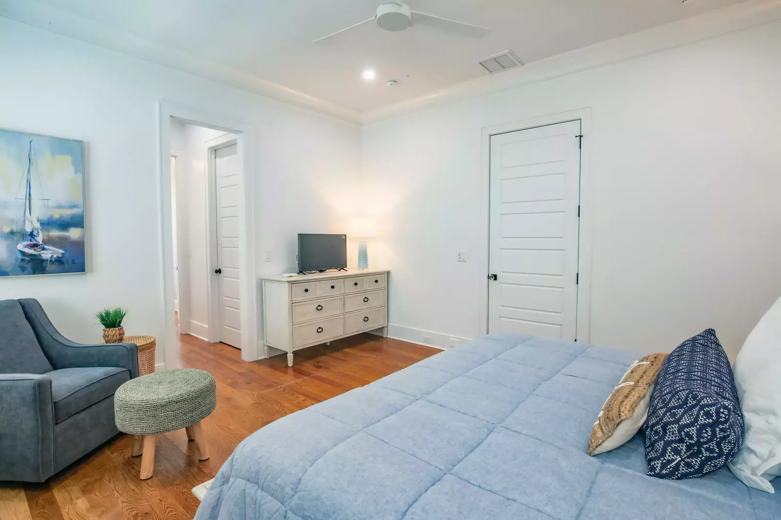The en suite bathroom for this lower level bedroom is accessible through the small hallway in this photo.