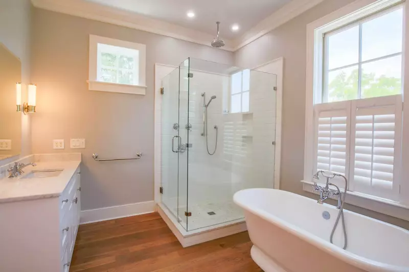 The lower level master suite features a soaking tub, double vanities and tiled, walk-in shower.