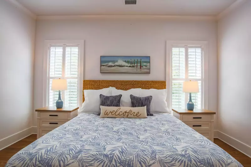 This master suite features a king bed and two night stands with reading lamps.