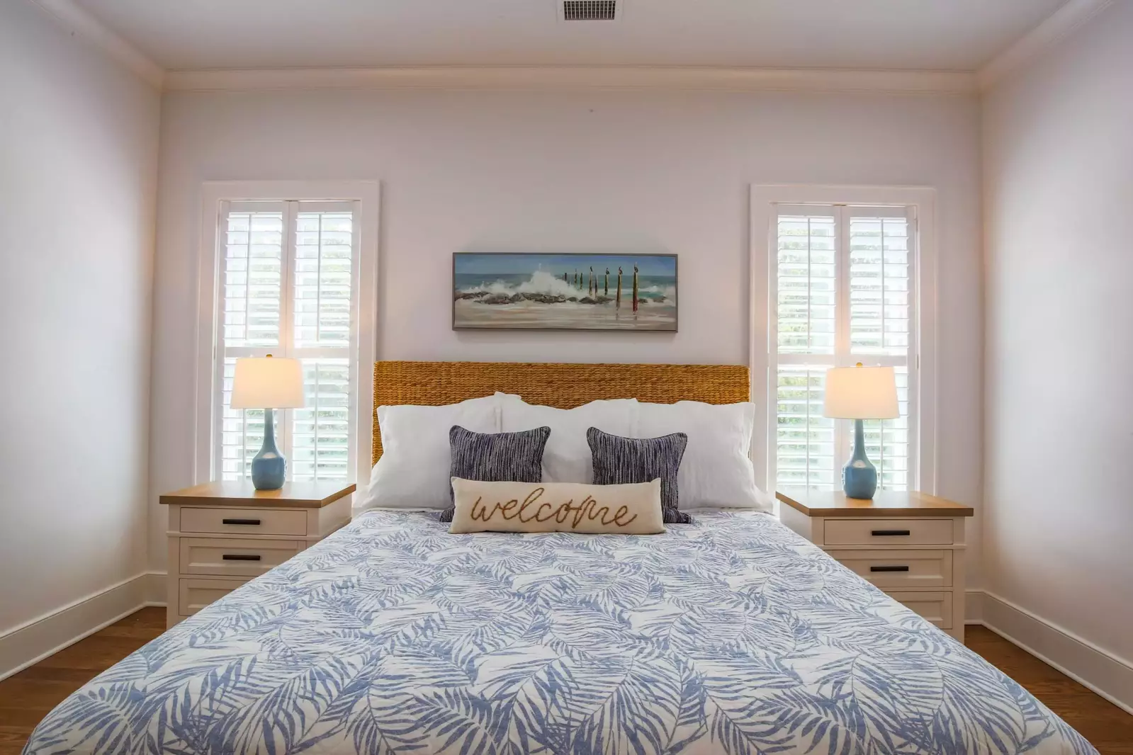 This master suite features a king bed and two night stands with reading lamps.