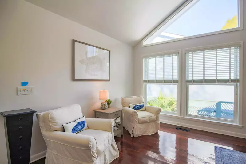 The living room receives lovely natural light through all its nearly floor-to-ceiling windows.