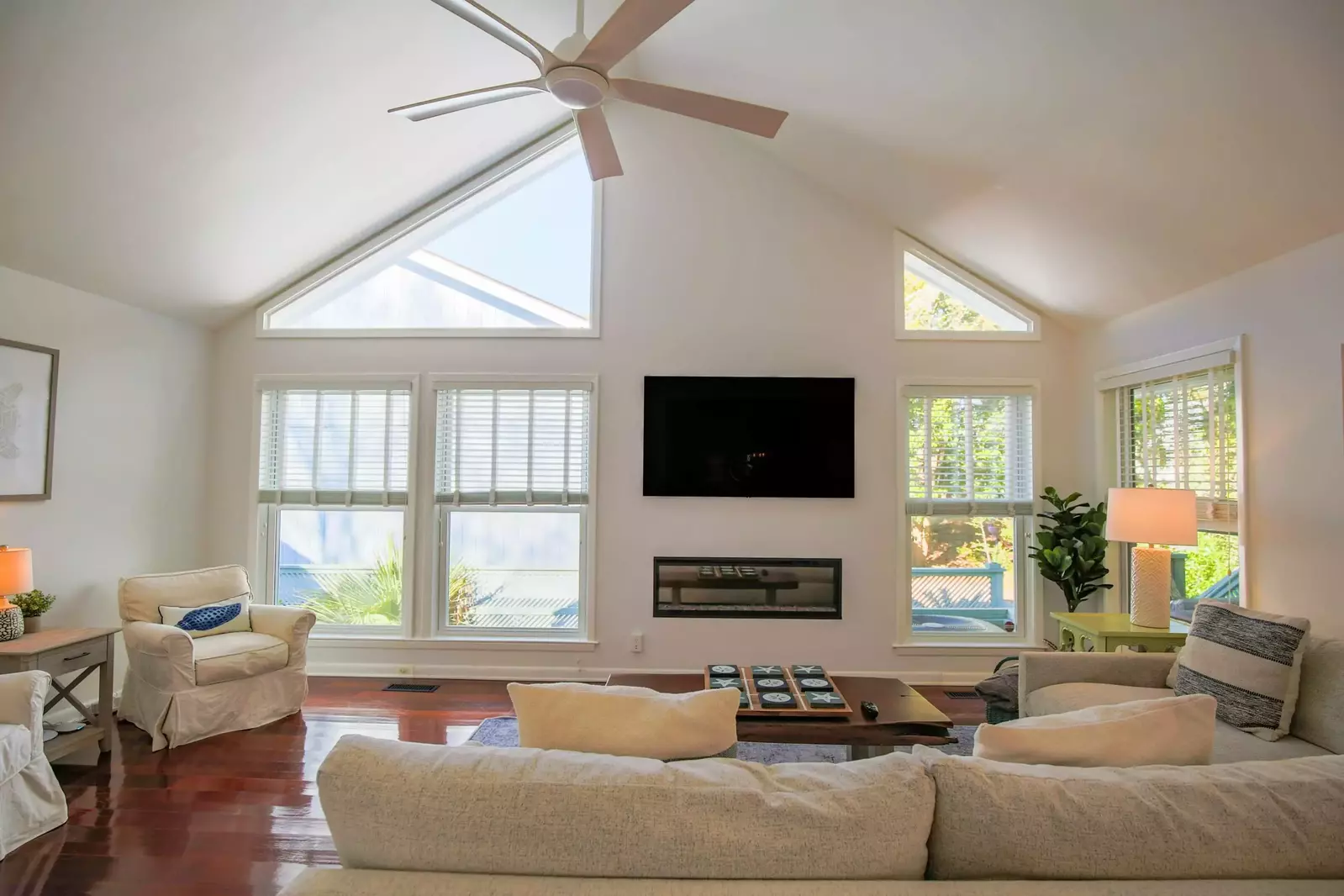 The living room features vaulted ceilings, terrific natural light and a spacious seating area.
