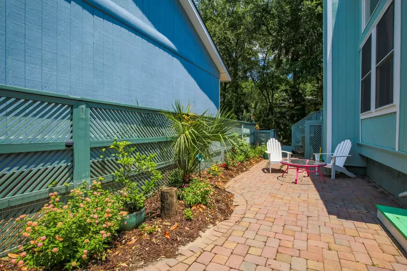 The sidewalk from the driveway to the front porch features lovely flowers & landscaping.