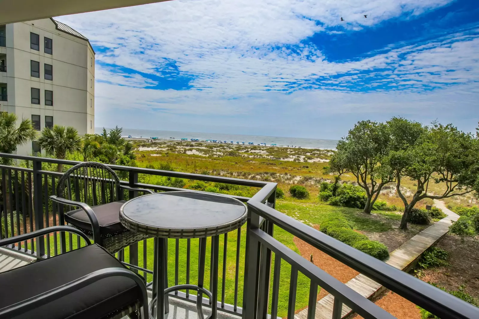 The covered balcony, with ocean views, is accessible from both the living room and master bedroom.